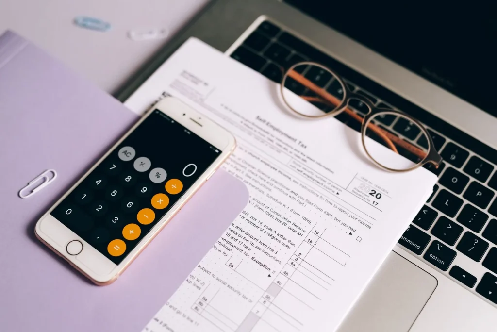 Calculator and financial documents used to evaluate rental returns