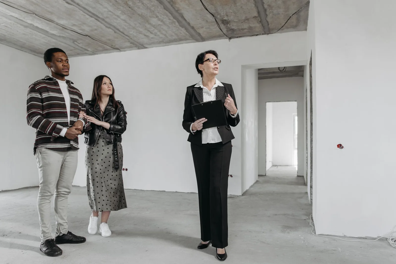 Buyers inspecting a property with a real estate adviser