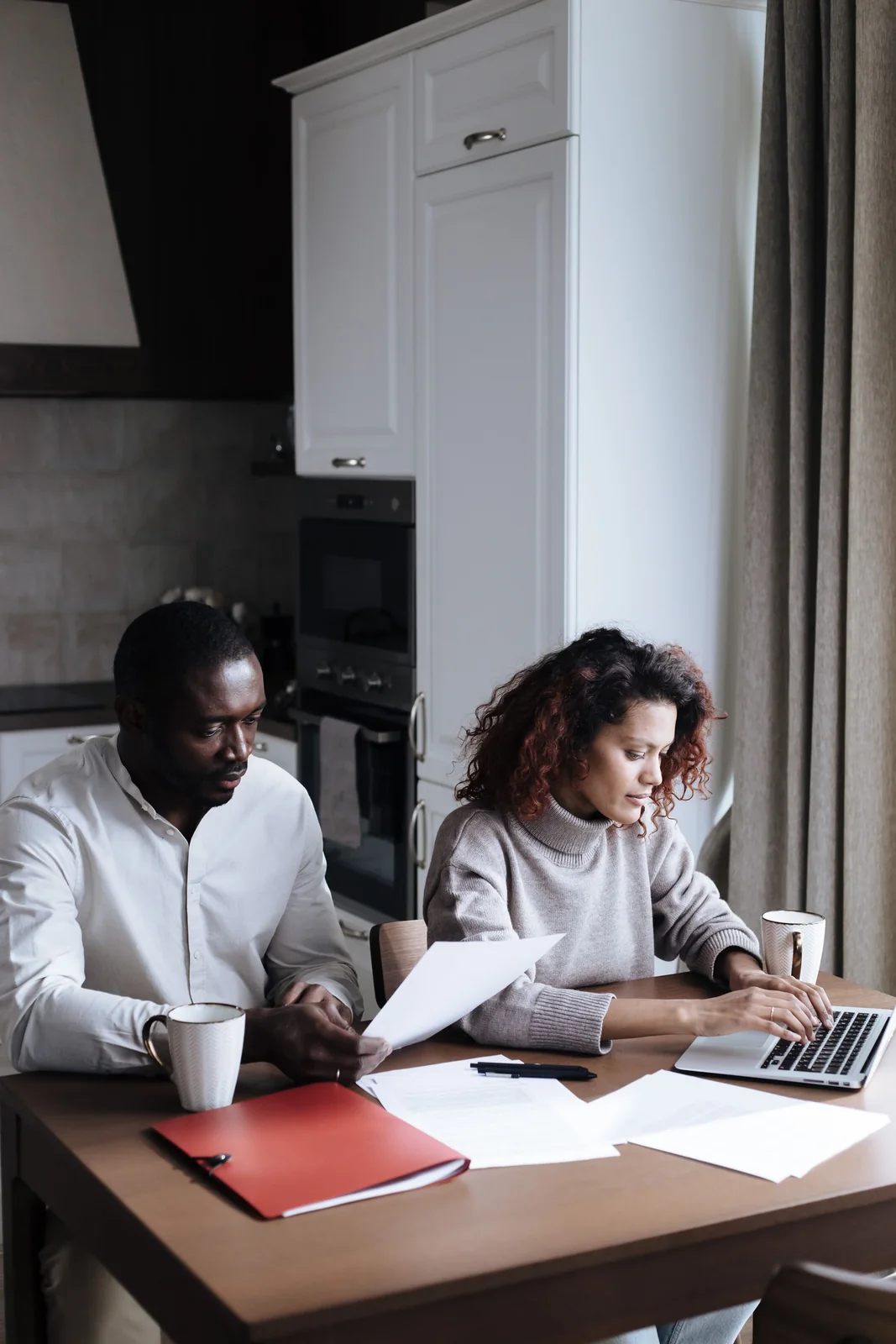 Investors reviewing documents before transferring capital